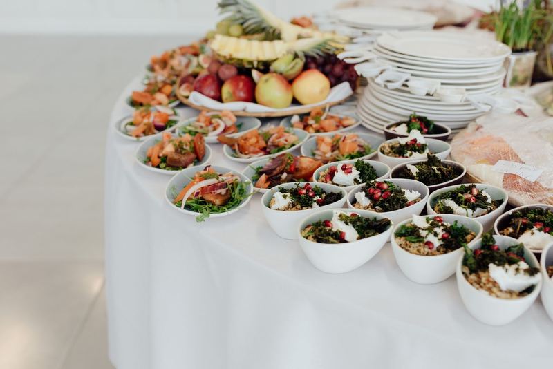 A catered spread of fresh dishes on a buffet table